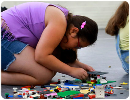 Camp Create Camper creating a STEM project from Legos