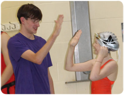 Noah Richardson high fiving a swimmer