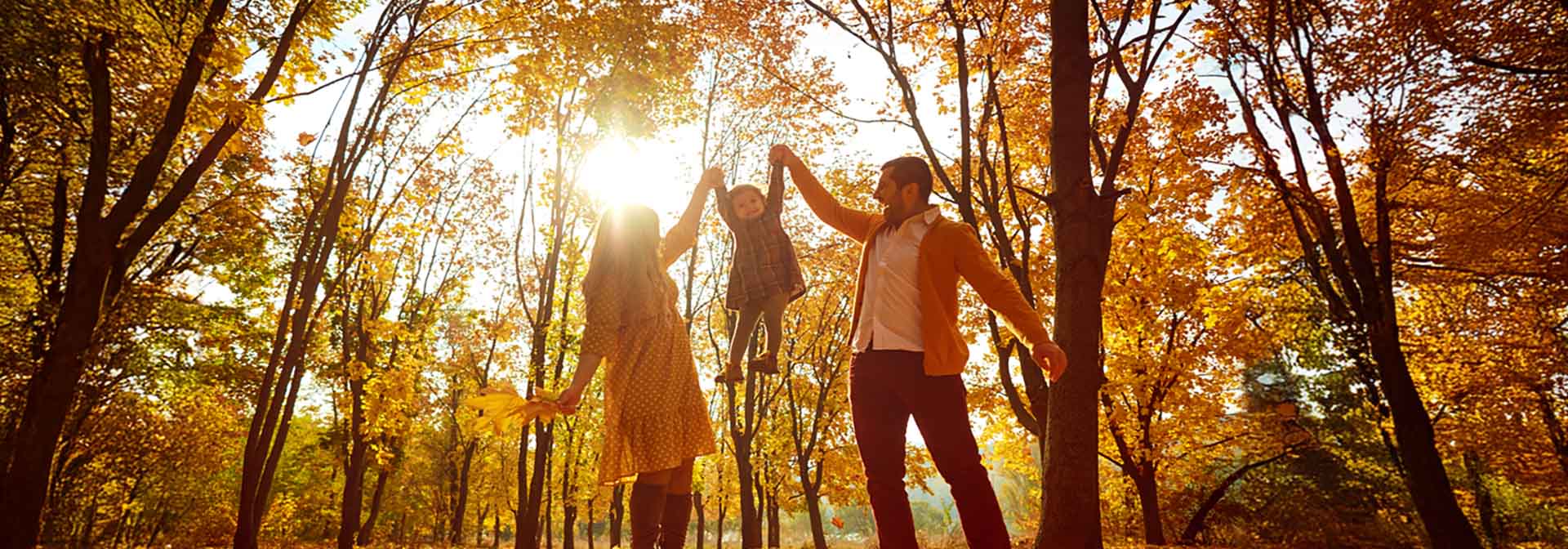 Family holding child up high