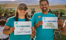 Y Staff holding welcome signs